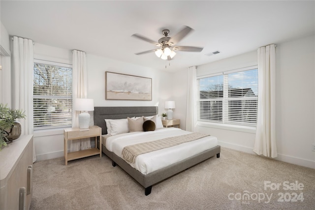 bedroom with ceiling fan and light colored carpet