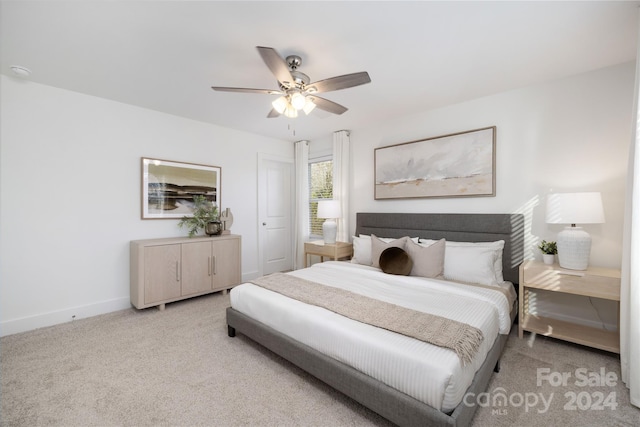 bedroom featuring light carpet and ceiling fan