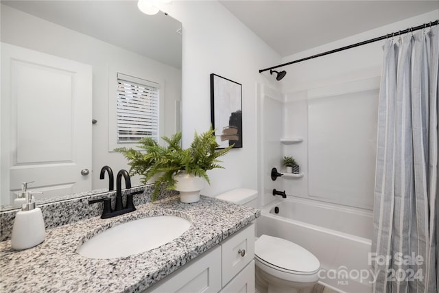 full bathroom with shower / bath combo with shower curtain, vanity, and toilet