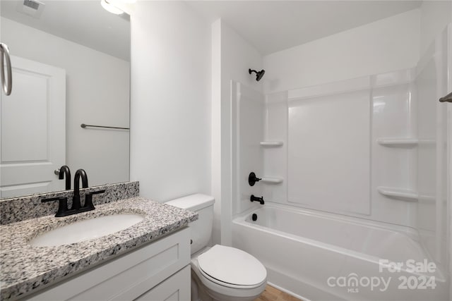 full bathroom featuring vanity,  shower combination, and toilet