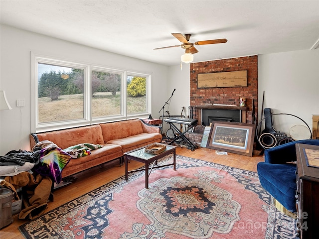 living room featuring ceiling fan and light wood-type flooring