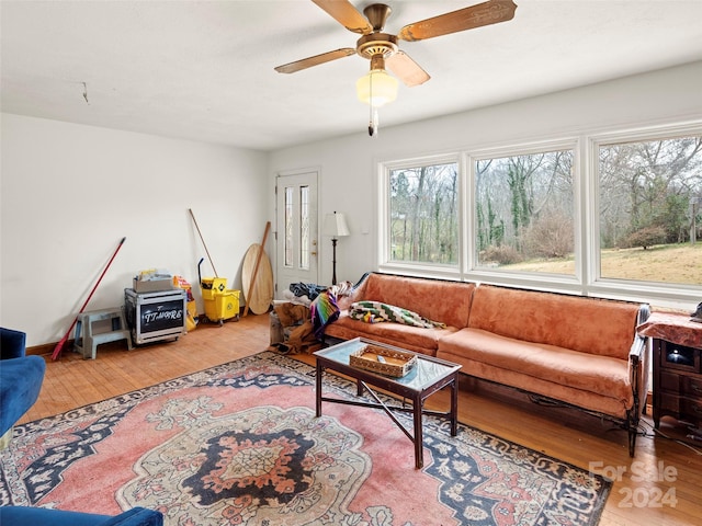 living room featuring ceiling fan and light hardwood / wood-style flooring