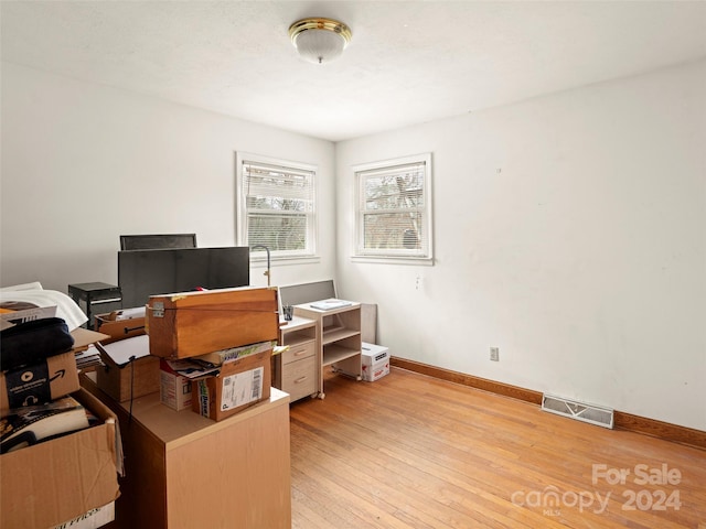 home office with light hardwood / wood-style floors