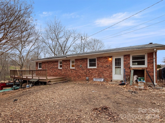 rear view of property featuring a deck