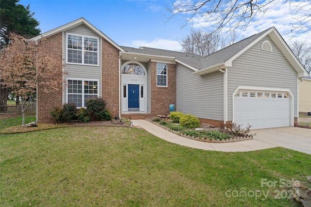 front of property with a front yard and a garage