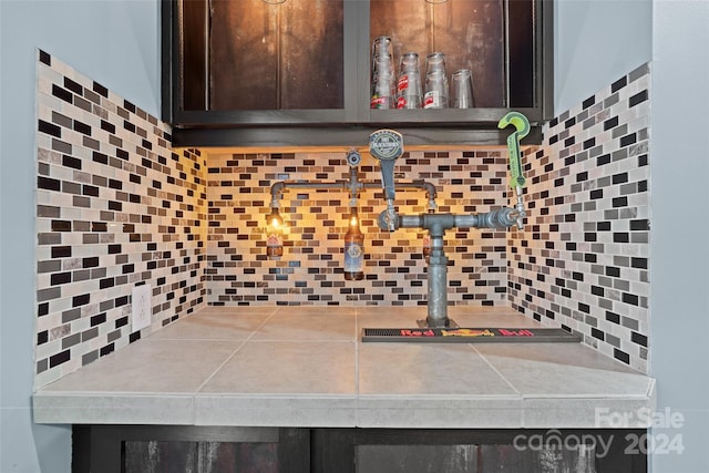 kitchen with tasteful backsplash and dark brown cabinets