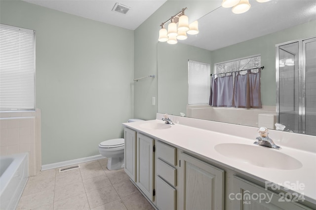 full bathroom with tile patterned flooring, vanity, separate shower and tub, and toilet