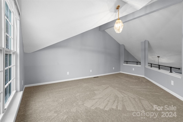 bonus room with carpet flooring and lofted ceiling