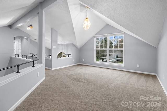 additional living space featuring vaulted ceiling with beams, carpet floors, and a textured ceiling