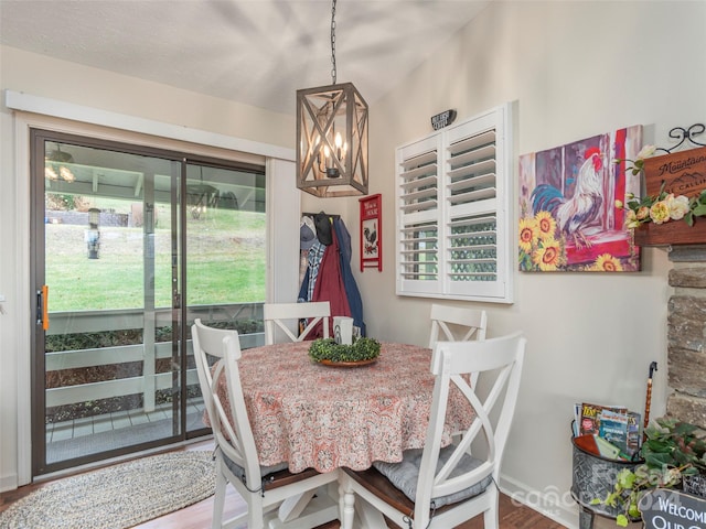 dining space featuring a wealth of natural light, hardwood / wood-style floors, and lofted ceiling