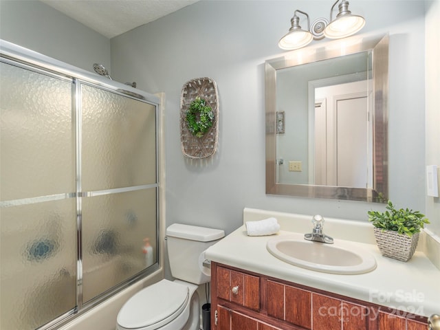 full bathroom featuring vanity, toilet, enclosed tub / shower combo, and a textured ceiling