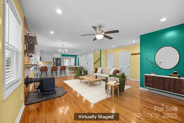 113 Burton St, Asheville, NC 28806 - living room featuring recessed lighting, a wood stove, light wood-style floors, baseboards, and ceiling fan