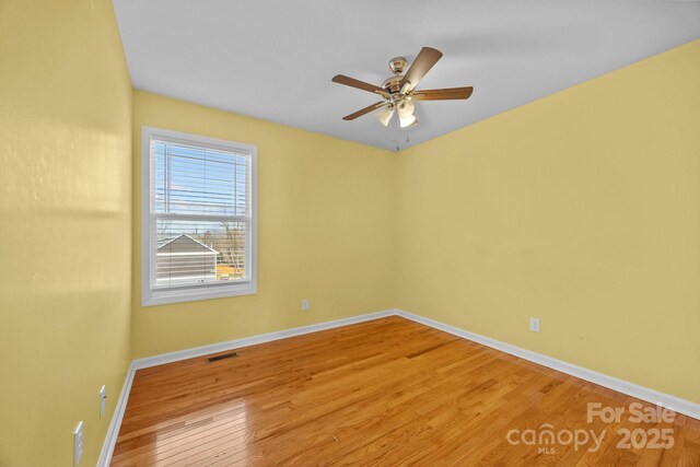 113 Burton St, Asheville, NC 28806 - unfurnished room featuring visible vents, baseboards, wood finished floors, and ceiling fan