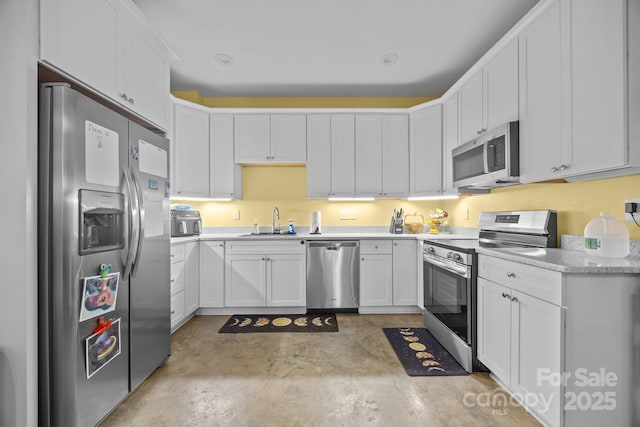 113 Burton St, Asheville, NC 28806 - kitchen with concrete flooring, appliances with stainless steel finishes, white cabinetry, and a sink