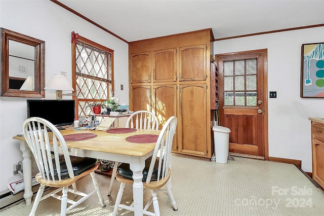 dining area with a wealth of natural light and crown molding