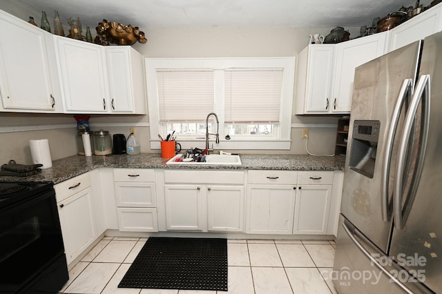 kitchen featuring white cabinets, sink, light tile patterned floors, and stainless steel refrigerator with ice dispenser