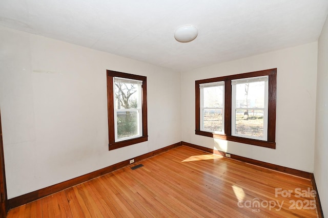 unfurnished room with light hardwood / wood-style floors