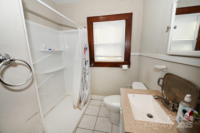 bathroom with toilet, sink, tile patterned flooring, and a shower with shower curtain