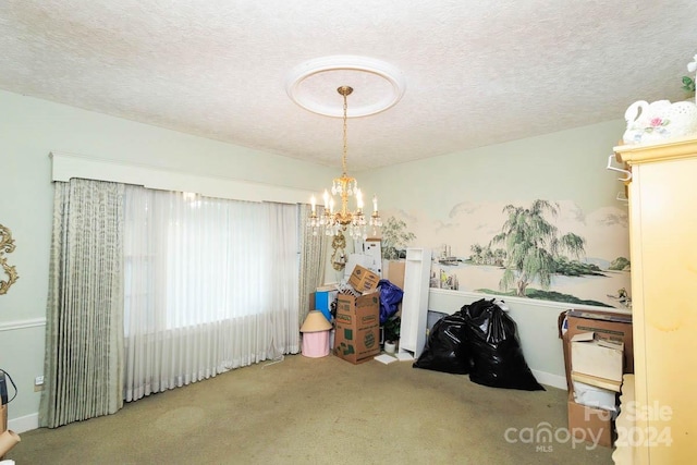 miscellaneous room featuring carpet flooring, a textured ceiling, and an inviting chandelier