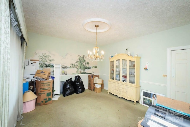 misc room with a textured ceiling, carpet floors, and an inviting chandelier