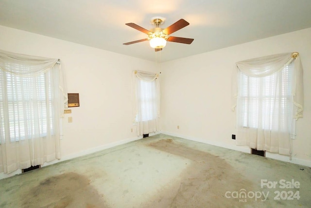 carpeted empty room with ceiling fan