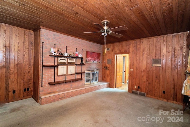 unfurnished living room featuring wooden walls, ceiling fan, wooden ceiling, and light carpet