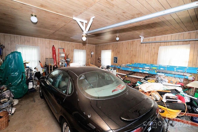 garage featuring wood walls and wooden ceiling