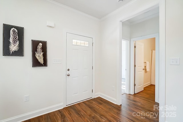 entrance foyer with dark hardwood / wood-style floors and ornamental molding