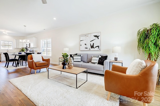 living room featuring a chandelier, hardwood / wood-style flooring, and a wealth of natural light