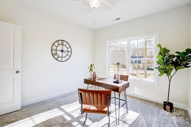 carpeted home office featuring ceiling fan