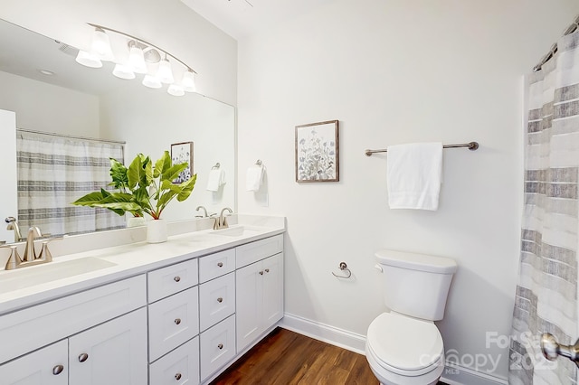 bathroom with vanity, toilet, wood-type flooring, and walk in shower