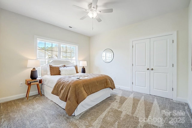 carpeted bedroom featuring a closet and ceiling fan