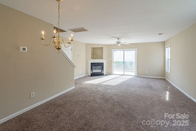 unfurnished living room with carpet flooring and ceiling fan with notable chandelier