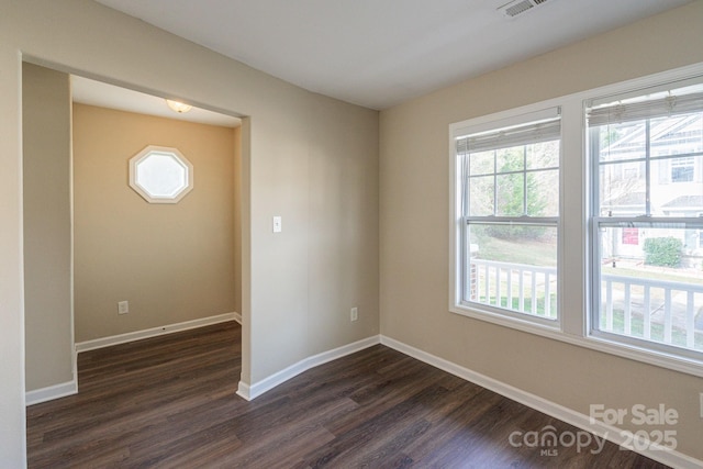 empty room featuring dark hardwood / wood-style flooring