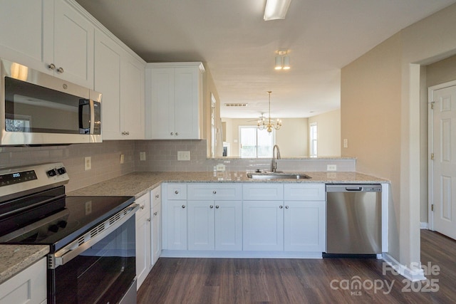 kitchen with white cabinets, appliances with stainless steel finishes, and sink