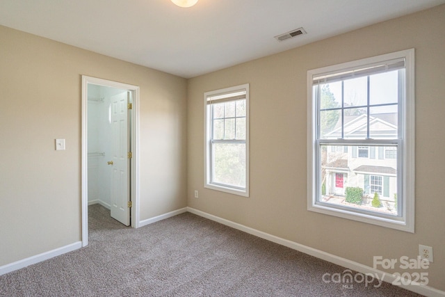 carpeted spare room with plenty of natural light