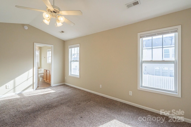 unfurnished bedroom with carpet, connected bathroom, vaulted ceiling, and ceiling fan