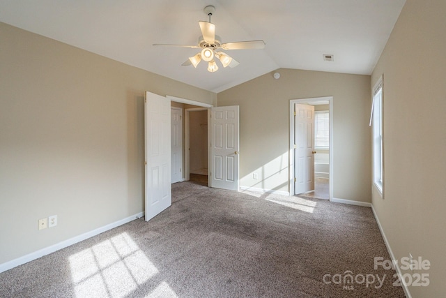 unfurnished bedroom with carpet, ceiling fan, lofted ceiling, and ensuite bathroom