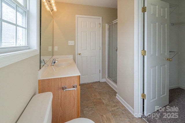 bathroom featuring vanity and a shower with shower door