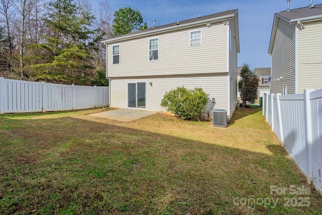 rear view of property featuring a yard, a patio, and central AC