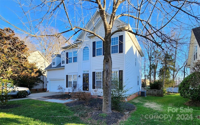 view of front of property featuring central AC, a front lawn, and a garage