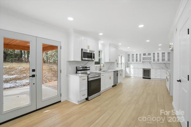 kitchen featuring french doors, white cabinets, and appliances with stainless steel finishes