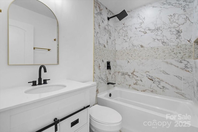 full bathroom featuring vanity, tiled shower / bath combo, and toilet