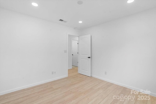 unfurnished room with light wood-type flooring