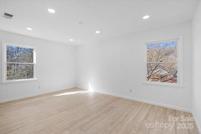 spare room with light hardwood / wood-style flooring