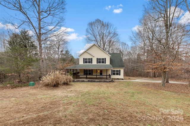 view of front of house with covered porch and a front yard