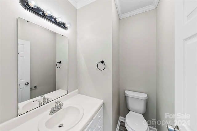 bathroom featuring vanity, toilet, and crown molding