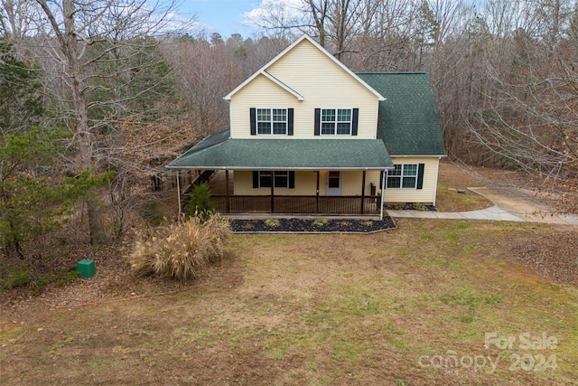 view of front of property with covered porch and a front yard