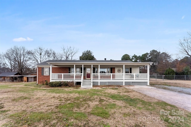 view of front of home with a porch and a front lawn