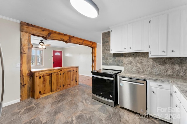 kitchen featuring decorative backsplash, white cabinetry, ceiling fan, and appliances with stainless steel finishes